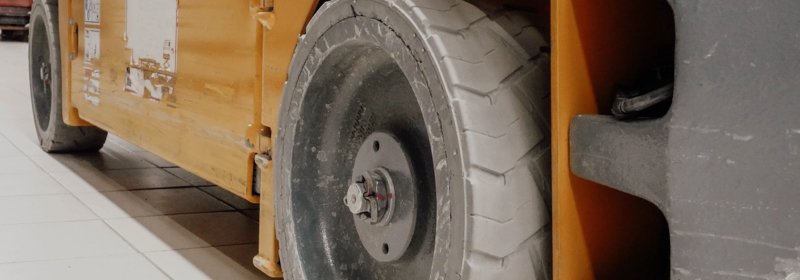 Industrial forklift wheel showing the importance of tire maintenance.