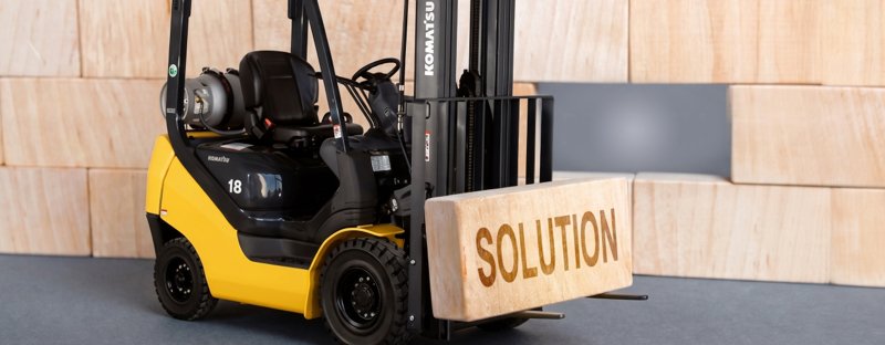 Chariot élévateur transportant une charge avec le mot solution.